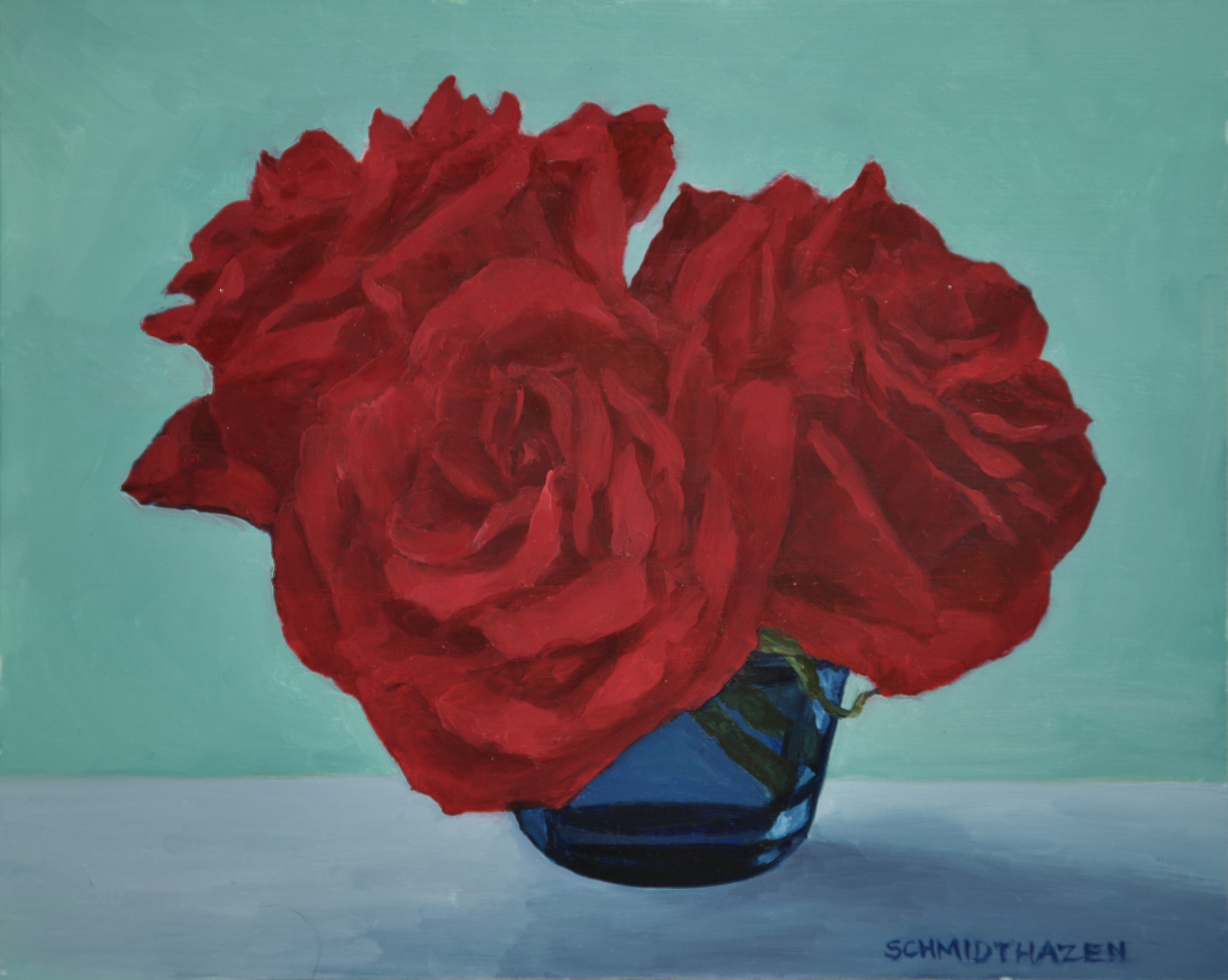 3 red roses with blue jar and green background